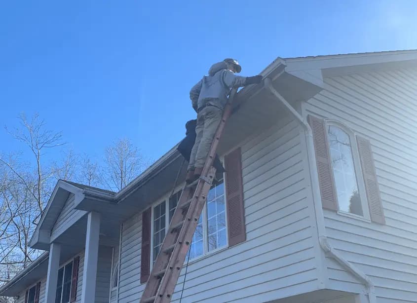 Gutter cleaning and maintenance being performed by Maple Heights Power Washing in Maple Heights